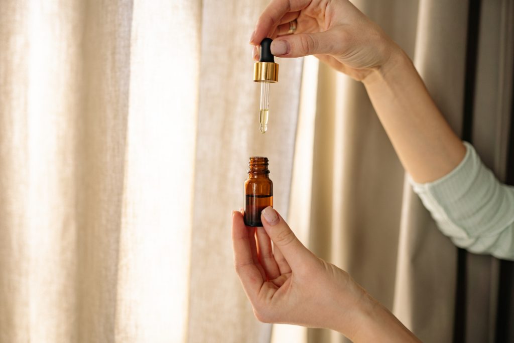 A person holding a CBD oil bottle