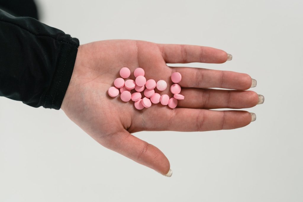 Prescription drugs on a woman’s palm